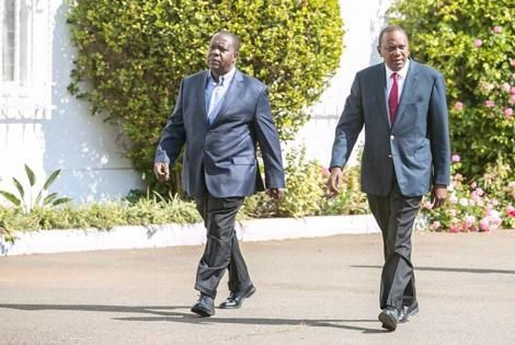 President Uhuru Kenyatta (Right) strolls at State House with Interior CS Fred Matiang'i during a past event.